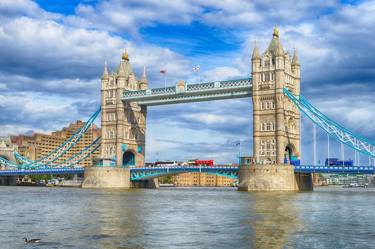 Tower bridge over the river thames on a partly cloudy day in the English capital city of London.