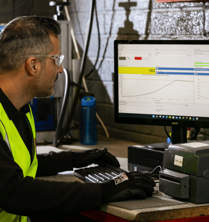 A man working on fluid power solutions using a computer.